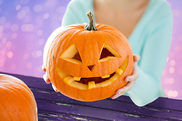 Image showing close up of woman with halloween pumpkin