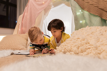 Image showing boys with magnifier and map in kids tent at home