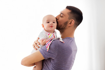 Image showing father kissing little baby daughter