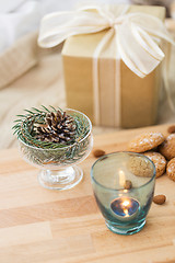 Image showing christmas fir decoration, candle, cookies and gift