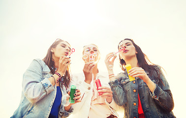 Image showing young women or girls blowing bubbles outdoors