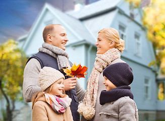 Image showing happy family over living house in autumn