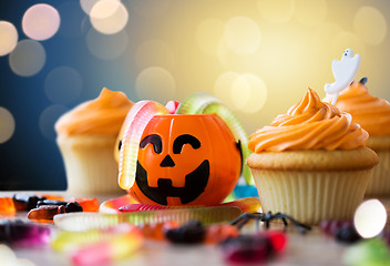 Image showing halloween party decorated cupcakes on wooden table
