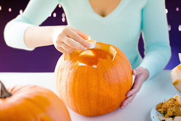 Image showing hands with candle and halloween pumpkin