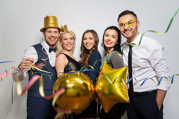 Image showing friends with party props and confetti laughing