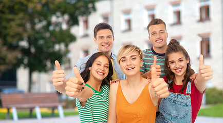 Image showing happy friends showing thumbs up