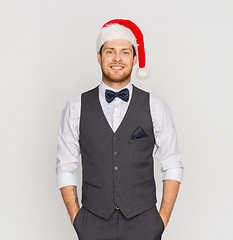 Image showing happy man in santa hat and suit at christmas