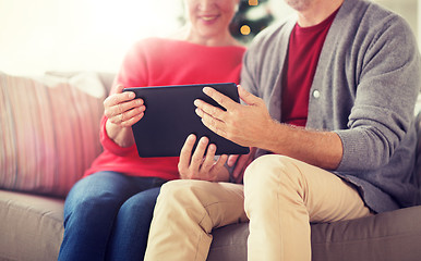 Image showing senior couple with tablet pc at christmas