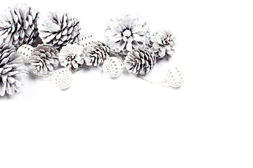 Image showing White decorative pine cones and balls.