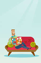 Image showing Man reading a magazine on the couch.
