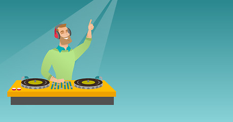 Image showing DJ mixing music on the turntables.