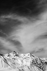 Image showing Black and white winter snowy mountains at windy day