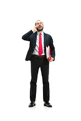 Image showing Happy businessman talking on the phone with folder in hand isolated over white background in studio shooting