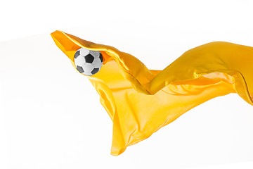 Image showing Soccer ball and Smooth elegant transparent yellow cloth isolated or separated on white studio background.