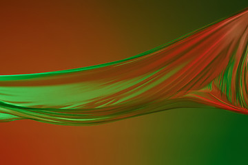 Image showing Smooth elegant transparent green cloth on green colored background.