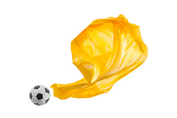 Image showing Soccer ball and Smooth elegant transparent yellow cloth isolated or separated on white studio background.