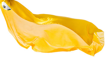 Image showing Soccer ball and Smooth elegant transparent yellow cloth isolated or separated on white studio background.