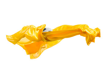 Image showing Soccer ball and Smooth elegant transparent yellow cloth isolated or separated on white studio background.