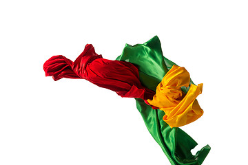 Image showing Smooth elegant transparent yellow, red, green cloth separated on white background.