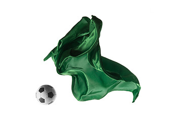 Image showing Soccer ball and Smooth elegant transparent green cloth isolated or separated on white studio background.