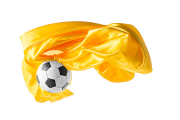 Image showing Soccer ball and Smooth elegant transparent yellow cloth isolated