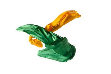 Image showing Smooth elegant transparent yellow, green cloth separated on white background.