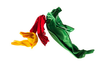 Image showing Smooth elegant transparent yellow, red, green cloth separated on white background.