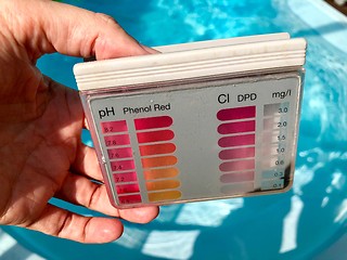 Image showing checking pH level in blue outdoor pool