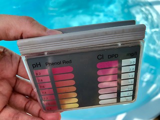 Image showing checking pH level in blue outdoor pool