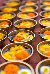 Image showing Buddhist flower offerings or gifts in bowls and rows