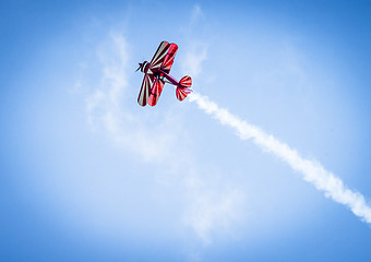 Image showing Red plane with propeller flying upward