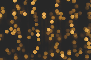 Image showing Golden glitter bokeh lights on a dark background