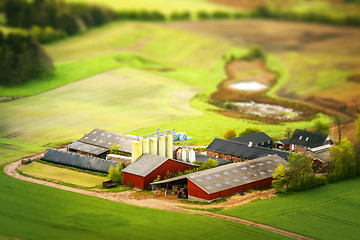 Image showing Rural farm in red colors with green fields