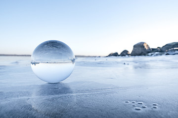 Image showing Glass orb on a frozen lake in the winter