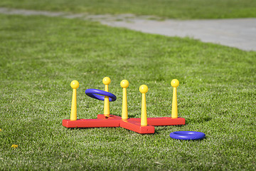 Image showing Ring throw summer game on a green lawn