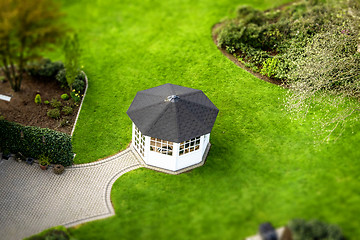 Image showing Small pavillon in a garden on a green lawn