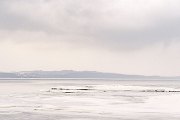 Image showing Ice on a lake in the winter with a misty landscape