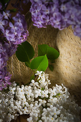 Image showing Still-life with a bouquet of lilacs and a straw hat, close-up