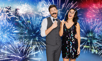 Image showing happy couple with party props having fun