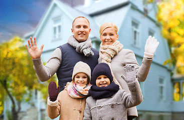 Image showing happy family over living house in autumn