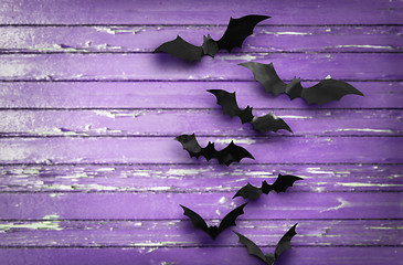 Image showing black bats over ultra violet shabby boards