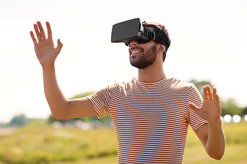 Image showing smiling man in virtual reality headset outdoors