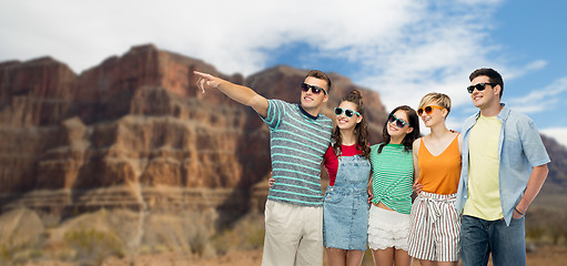 Image showing friends in sunglasses over grand canyon