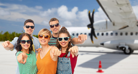 Image showing friends pointing at you over plane on airfield