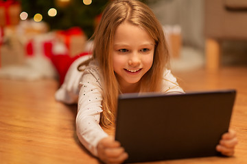 Image showing smiling girl with tablet pc at christmas home