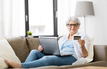 Image showing senior woman with laptop and credit card at home