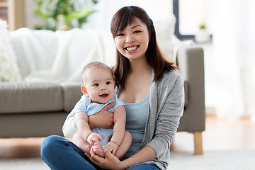 Image showing happy young mother with little baby at home