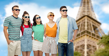 Image showing happy friends hugging over eiffel tower background