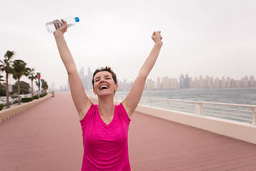 Image showing young woman celebrating a successful training run