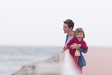 Image showing mother and cute little girl on the promenade by the sea